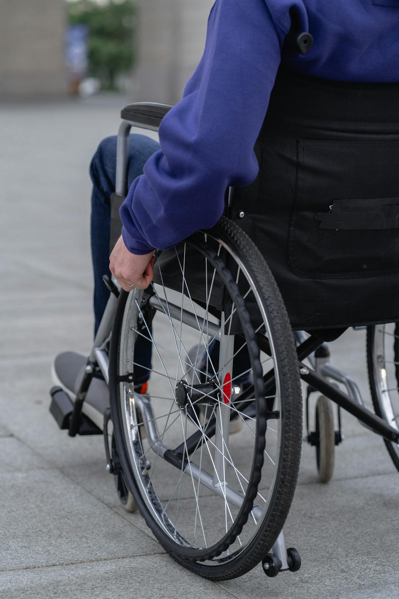 A person in a wheelchair outdoors, focusing on mobility and independence.